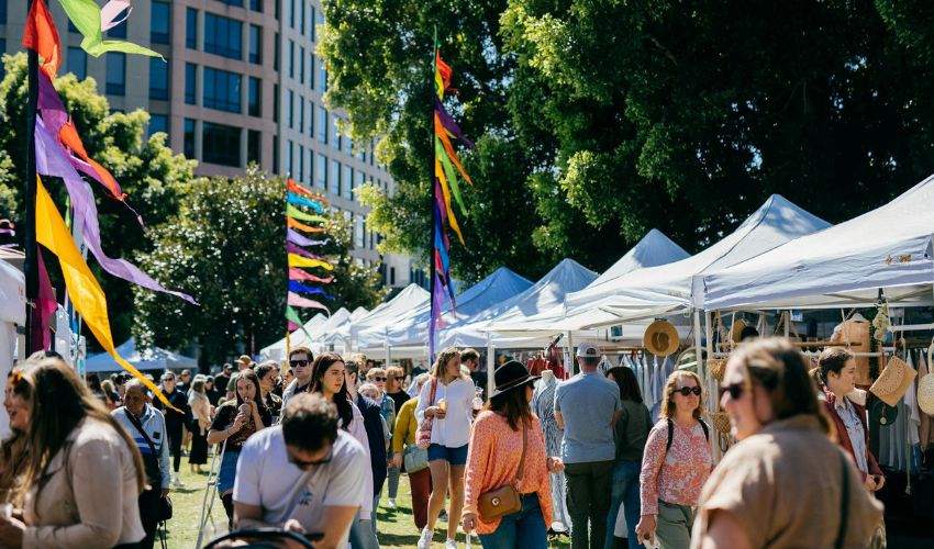 Stalls and visitors browsing handmade goods at Olive Tree Markets in Newcastle