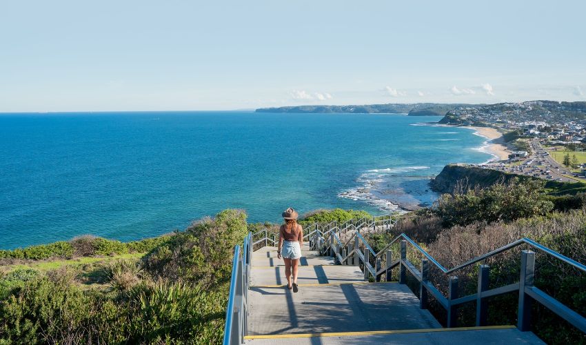 Visitors walking along the Newcastle Memorial Walk overlooking the coastline and Pacific Ocean.