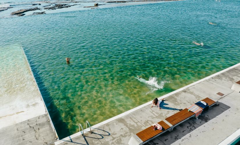 Diving in to the clear turquoise water of the Merewether Ocean Baths