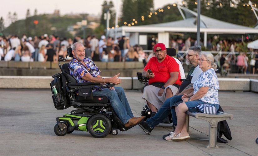 Two men in wheelchairs and two people on a bench enjoying the Accessible Viewing Platform