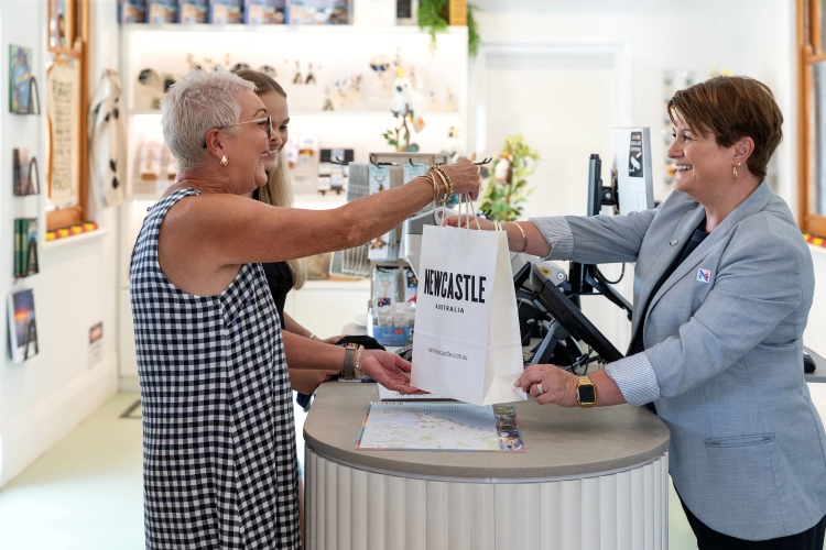 Shoppers making a purchase at the Visitor Information Centre