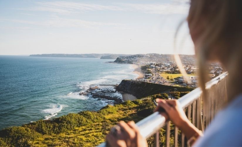 Visitor overlooking Bar Beach and Merewether coastline from Newcastle Memorial Walk along Bathers Way