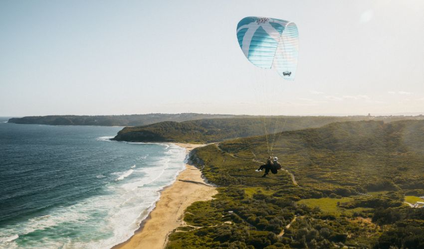 A hang-glider floats above Glenrock after taking off from Hickson Street Lookout