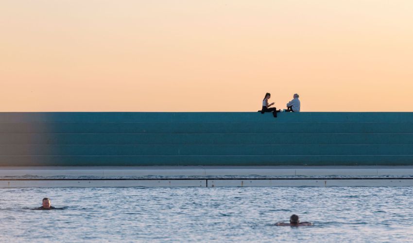 Sunrise glow over the aqua steps at Newcastle Ocean Baths